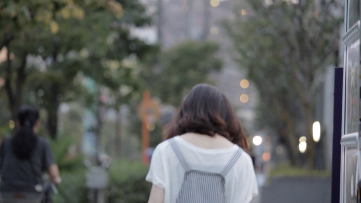 夕方の並木道を歩く後ろ姿